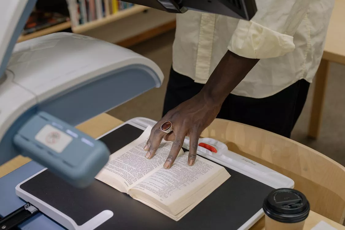 Someone scanning a book at the library.